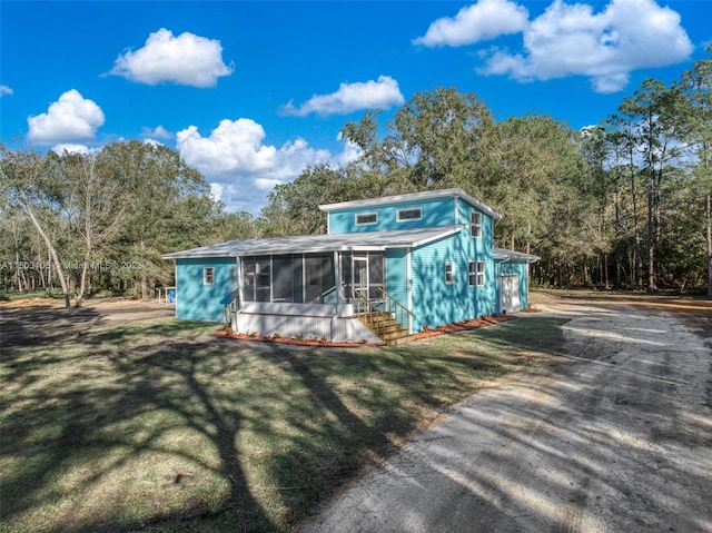 104 Ballard, Avon Park, FL 33825 - view of front of home with a sunroom and a front lawn
