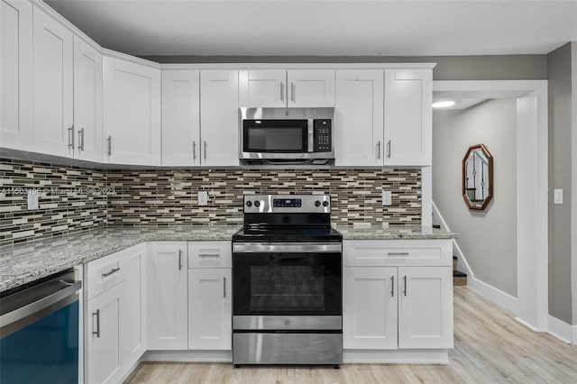 kitchen featuring light hardwood / wood-style floors, white cabinetry, tasteful backsplash, and stainless steel appliances