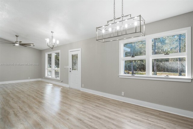 104 Ballard, Avon Park, FL 33825 - unfurnished living room featuring a chandelier, wood finished floors, baseboards, and a ceiling fan