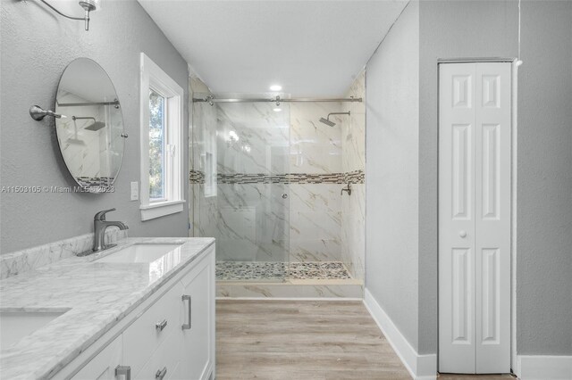 104 Ballard, Avon Park, FL 33825 - bathroom with a closet, a marble finish shower, double vanity, and wood finished floors