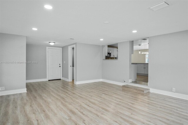 104 Ballard, Avon Park, FL 33825 - empty room with recessed lighting, light wood-style flooring, baseboards, and a chandelier