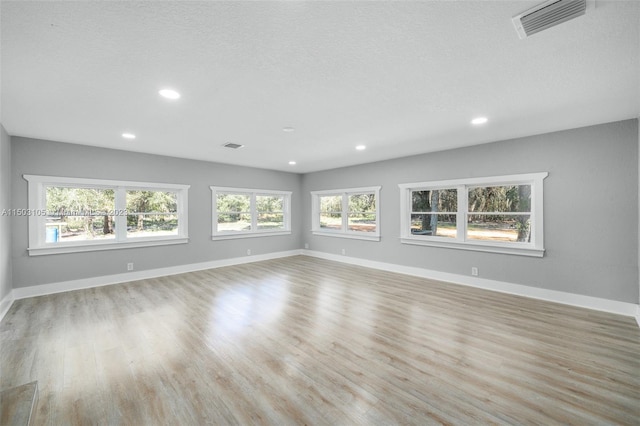 interior space featuring light hardwood / wood-style floors and a textured ceiling