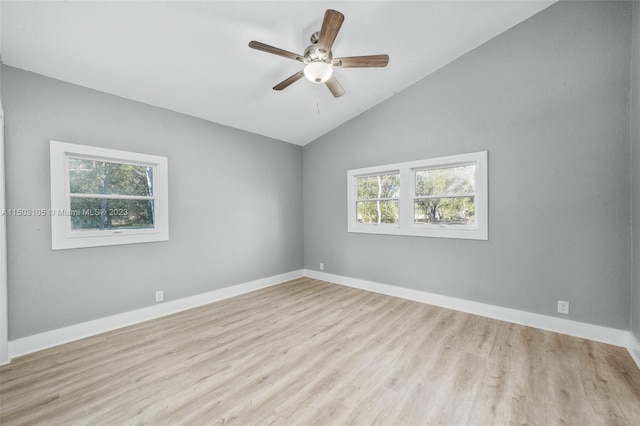 spare room with light hardwood / wood-style floors, vaulted ceiling, and ceiling fan