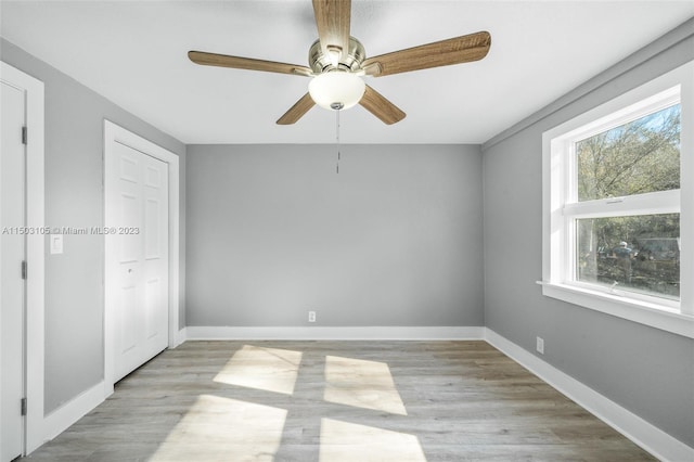 spare room featuring light hardwood / wood-style flooring and ceiling fan