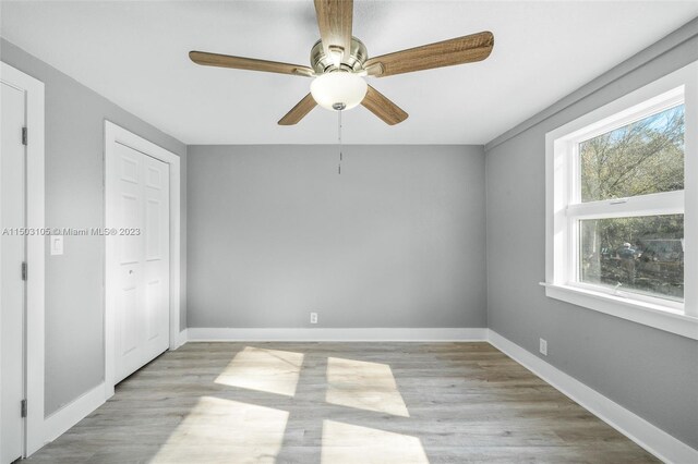104 Ballard, Avon Park, FL 33825 - unfurnished bedroom featuring light wood-style floors, baseboards, a ceiling fan, and a closet