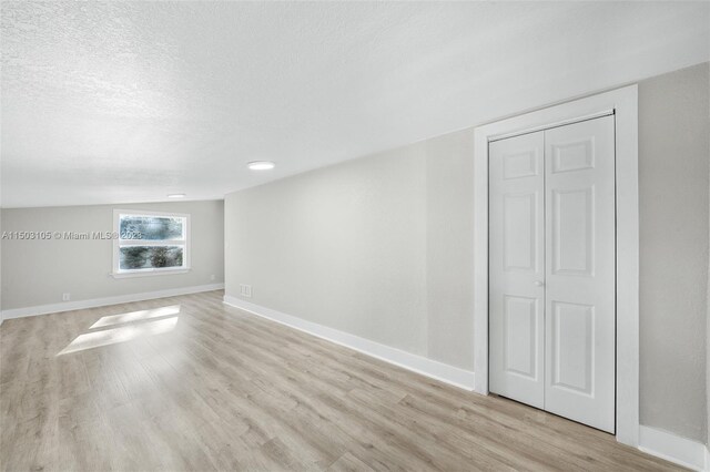 104 Ballard, Avon Park, FL 33825 - empty room featuring light wood-style flooring, baseboards, and a textured ceiling