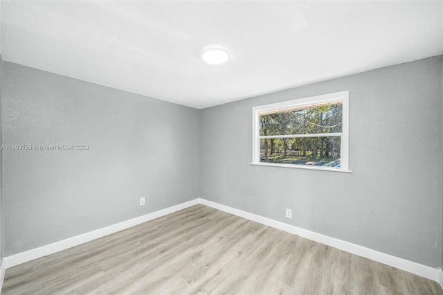 unfurnished room with hardwood / wood-style floors