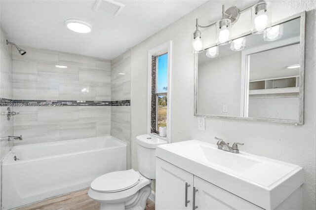 104 Ballard, Avon Park, FL 33825 - full bathroom featuring toilet, vanity,  shower combination, and wood finished floors