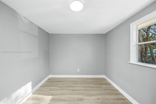 spare room with light hardwood / wood-style flooring