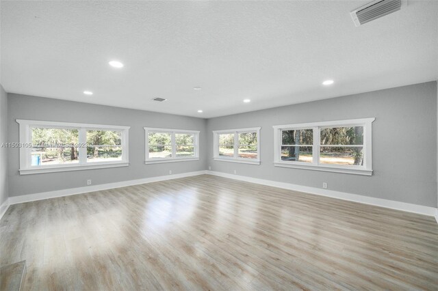 104 Ballard, Avon Park, FL 33825 - empty room featuring recessed lighting, light wood-style flooring, baseboards, and a textured ceiling