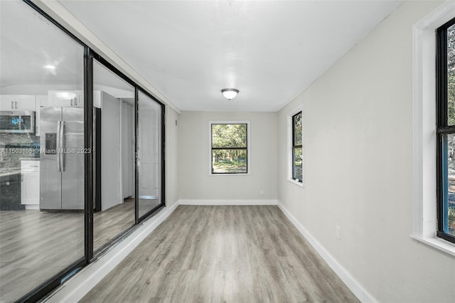 spare room with light wood-type flooring