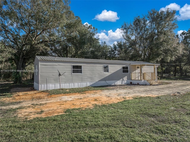 back of property featuring a yard