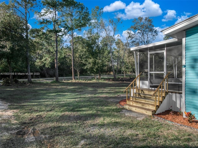 view of yard featuring a sunroom