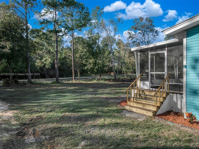 104 Ballard, Avon Park, FL 33825 - view of green lawn featuring a sunroom