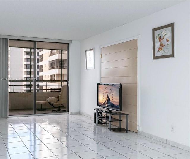 living room with a wall of windows and light tile patterned floors