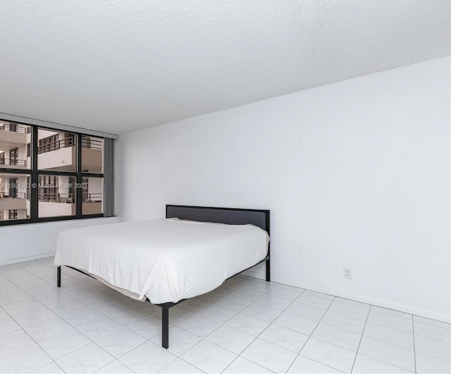 tiled bedroom with a textured ceiling