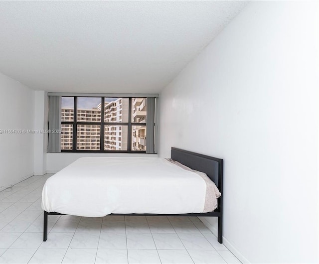 bedroom featuring tile patterned floors and a textured ceiling