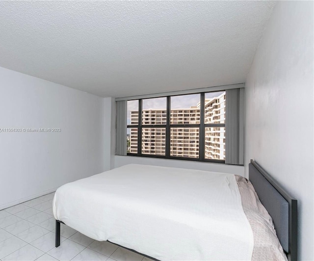 tiled bedroom with a textured ceiling