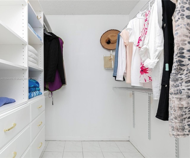 spacious closet featuring light tile patterned floors