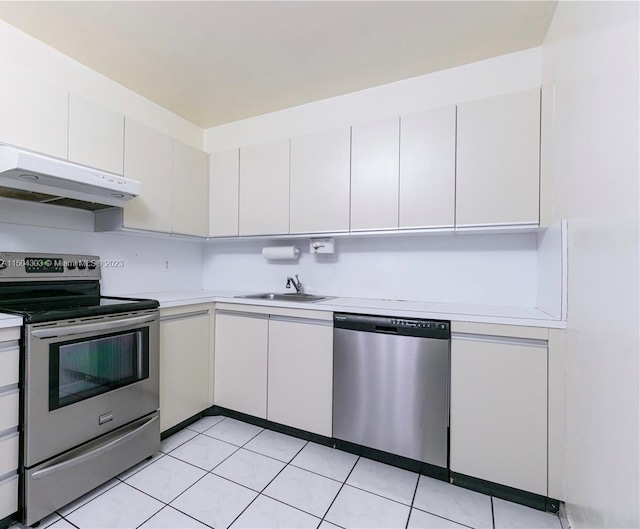 kitchen featuring light tile patterned floors, stainless steel appliances, sink, and white cabinets