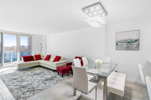 tiled dining room featuring an inviting chandelier