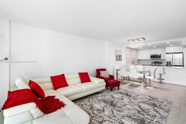 living room featuring light tile patterned flooring and a chandelier