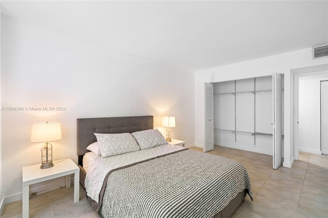 bedroom with light tile patterned floors