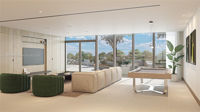 living room with floor to ceiling windows, a healthy amount of sunlight, and billiards