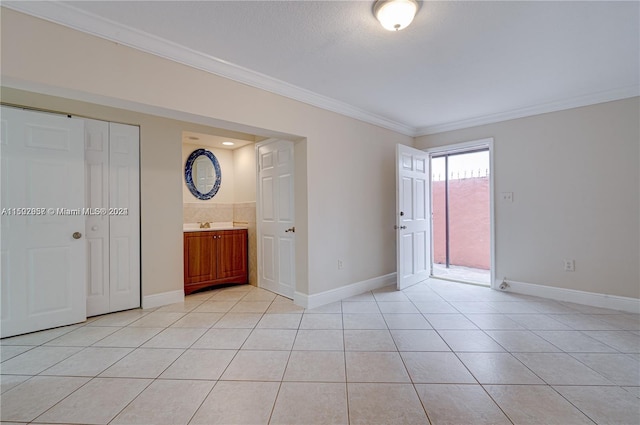 unfurnished room featuring light tile floors and crown molding