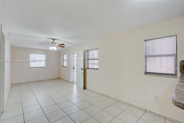 tiled spare room with ceiling fan