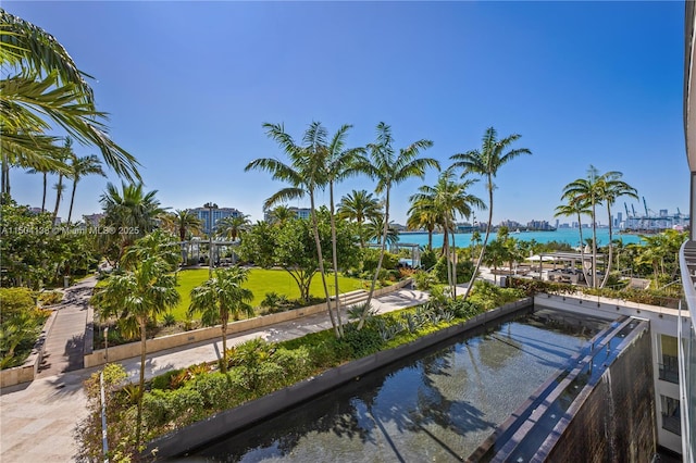 exterior space featuring a water view and a lawn