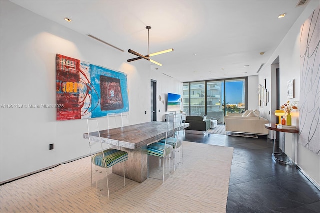 dining room with floor to ceiling windows and ceiling fan