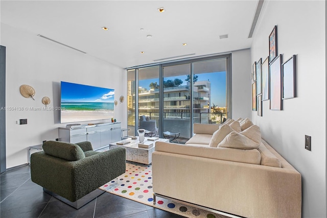 living room with floor to ceiling windows and tile patterned flooring