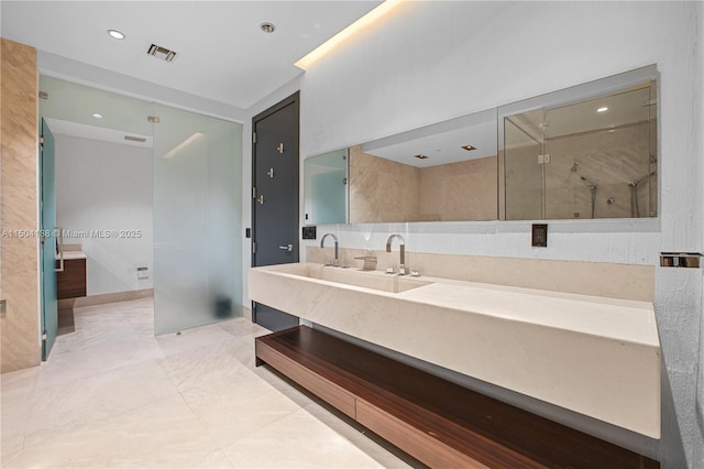 bathroom with vanity and a shower with shower door