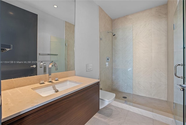 bathroom featuring an enclosed shower, vanity, and toilet