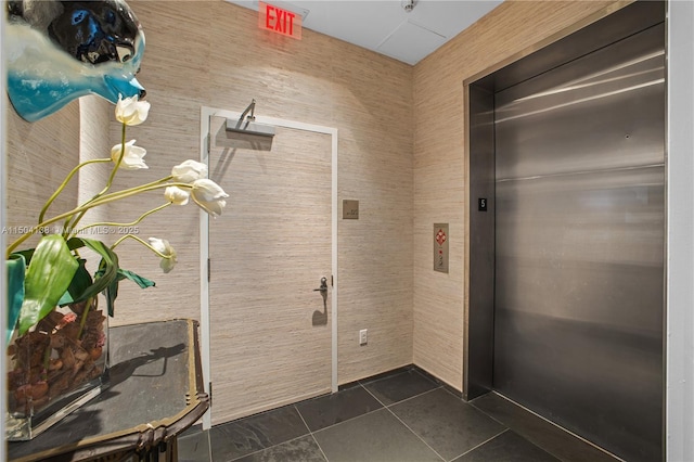 interior space with tile patterned flooring and elevator