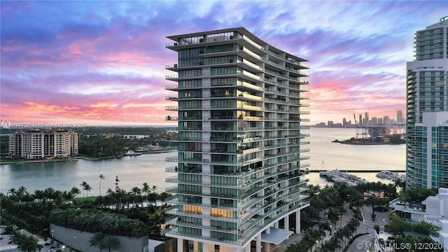 outdoor building at dusk featuring a water view