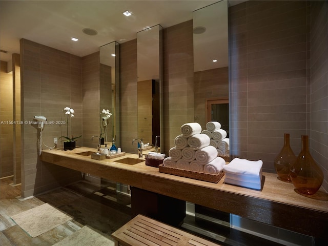 bathroom with tile walls and vanity