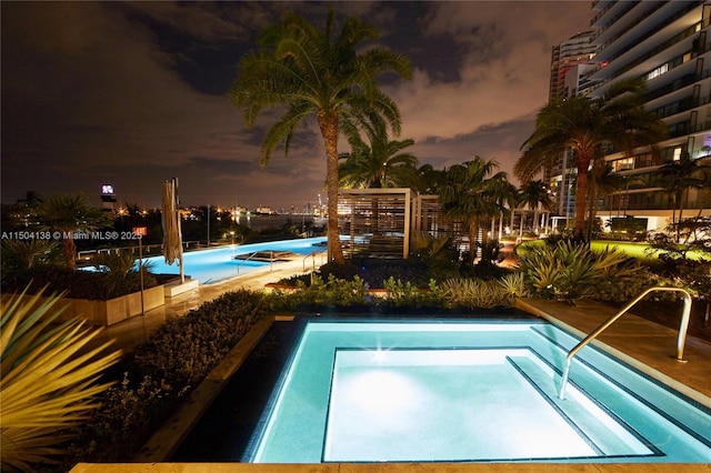 view of swimming pool with a community hot tub