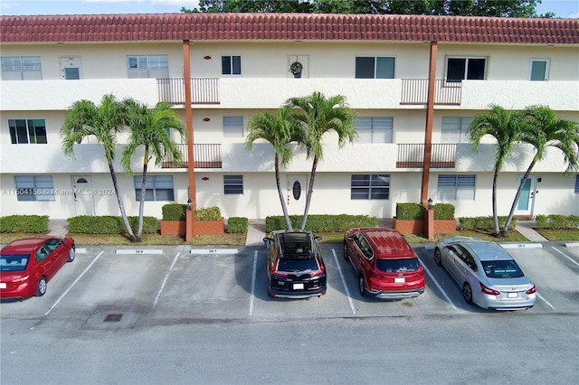 view of building exterior with uncovered parking