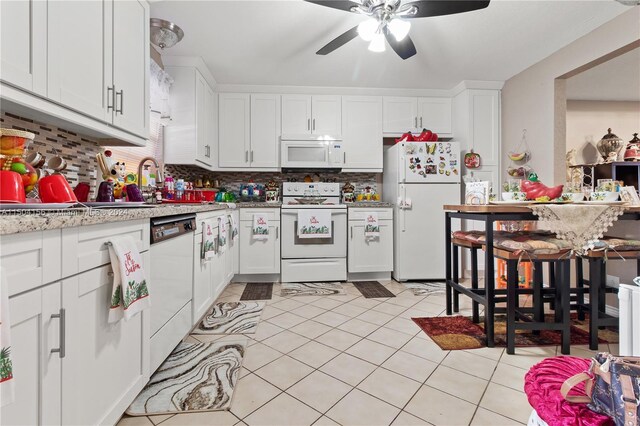 kitchen featuring white cabinetry, tasteful backsplash, white appliances, and ceiling fan