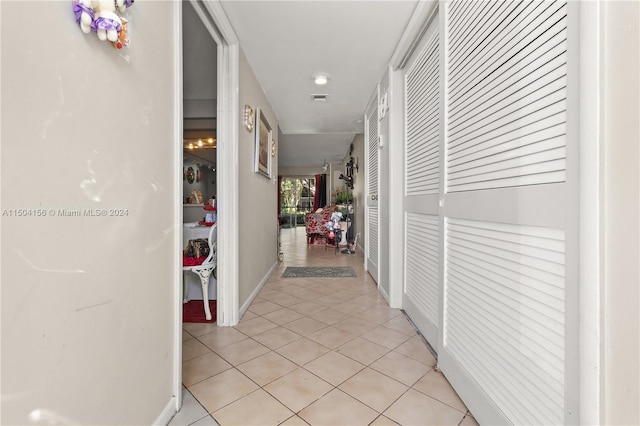 corridor featuring light tile patterned floors