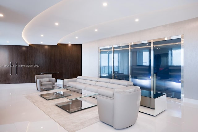 living room with wood walls and light tile flooring