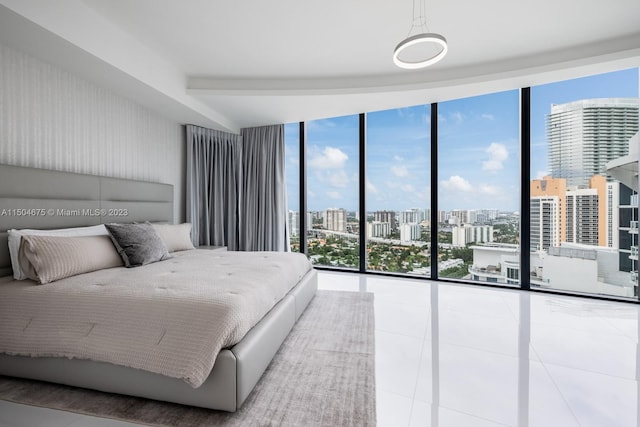 tiled bedroom featuring a wall of windows and access to exterior