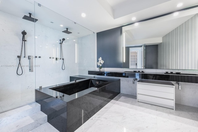 bathroom with tiled shower, oversized vanity, and tile flooring