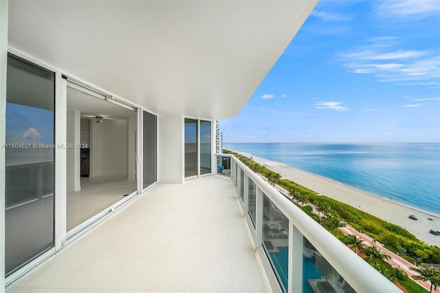 balcony featuring a beach view and a water view