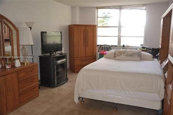 bedroom featuring light tile floors