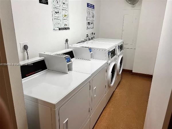 laundry area with independent washer and dryer, light tile flooring, and hookup for an electric dryer