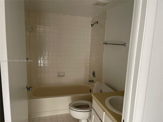 full bathroom with tile patterned floors, toilet, vanity, and tiled shower / bath