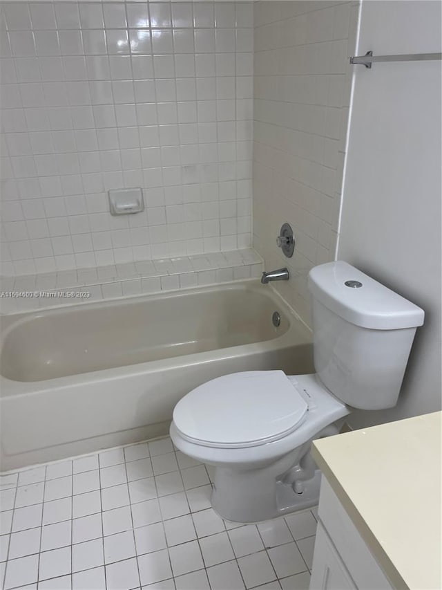 full bathroom featuring vanity, tile patterned flooring, tiled shower / bath, and toilet